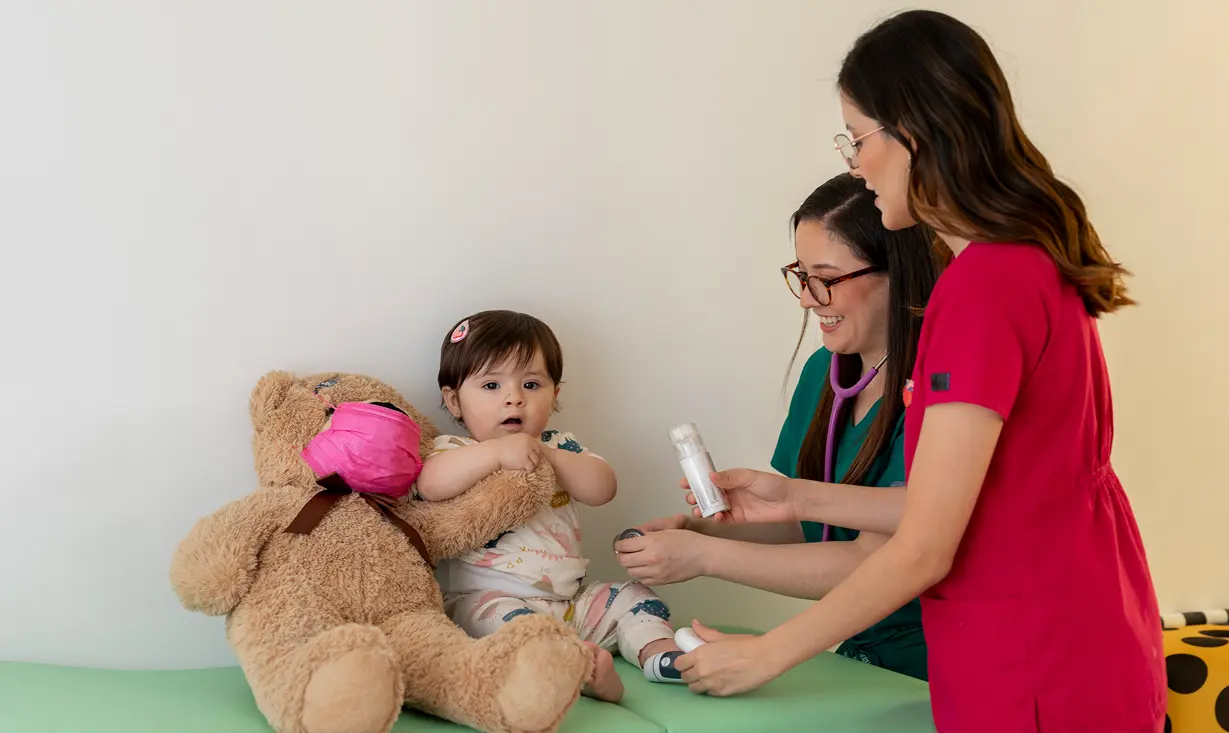 Child with doctors and teddy bear.